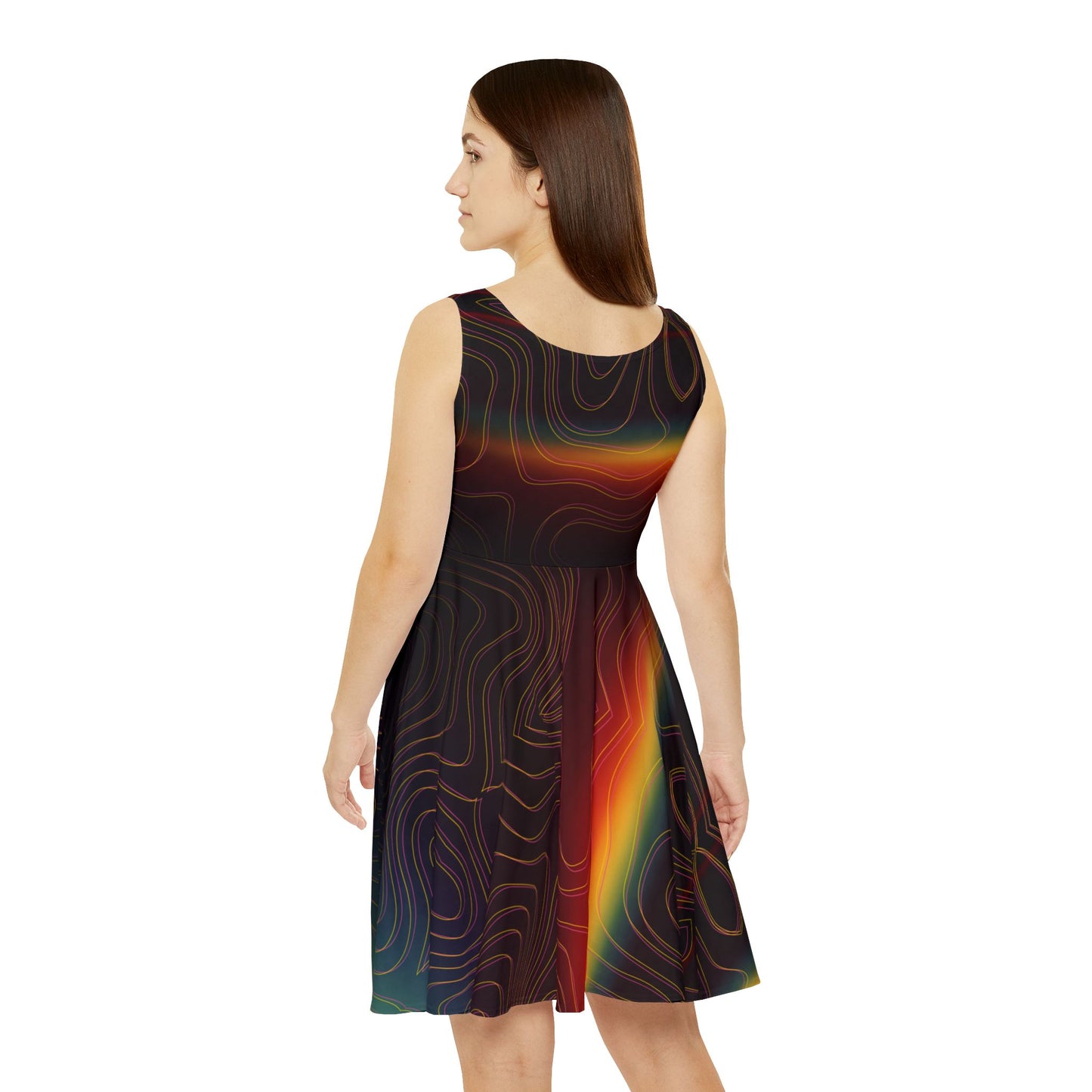 Woman wearing a sleeveless dress with a colorful rainbow pattern on a white background